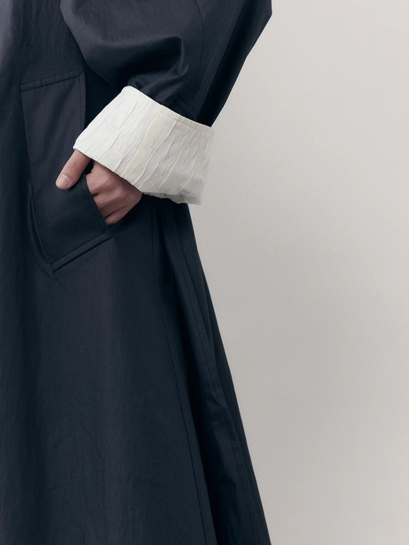 바이 컬러 니치 모노톤은 긴 코트를 주름지게했다