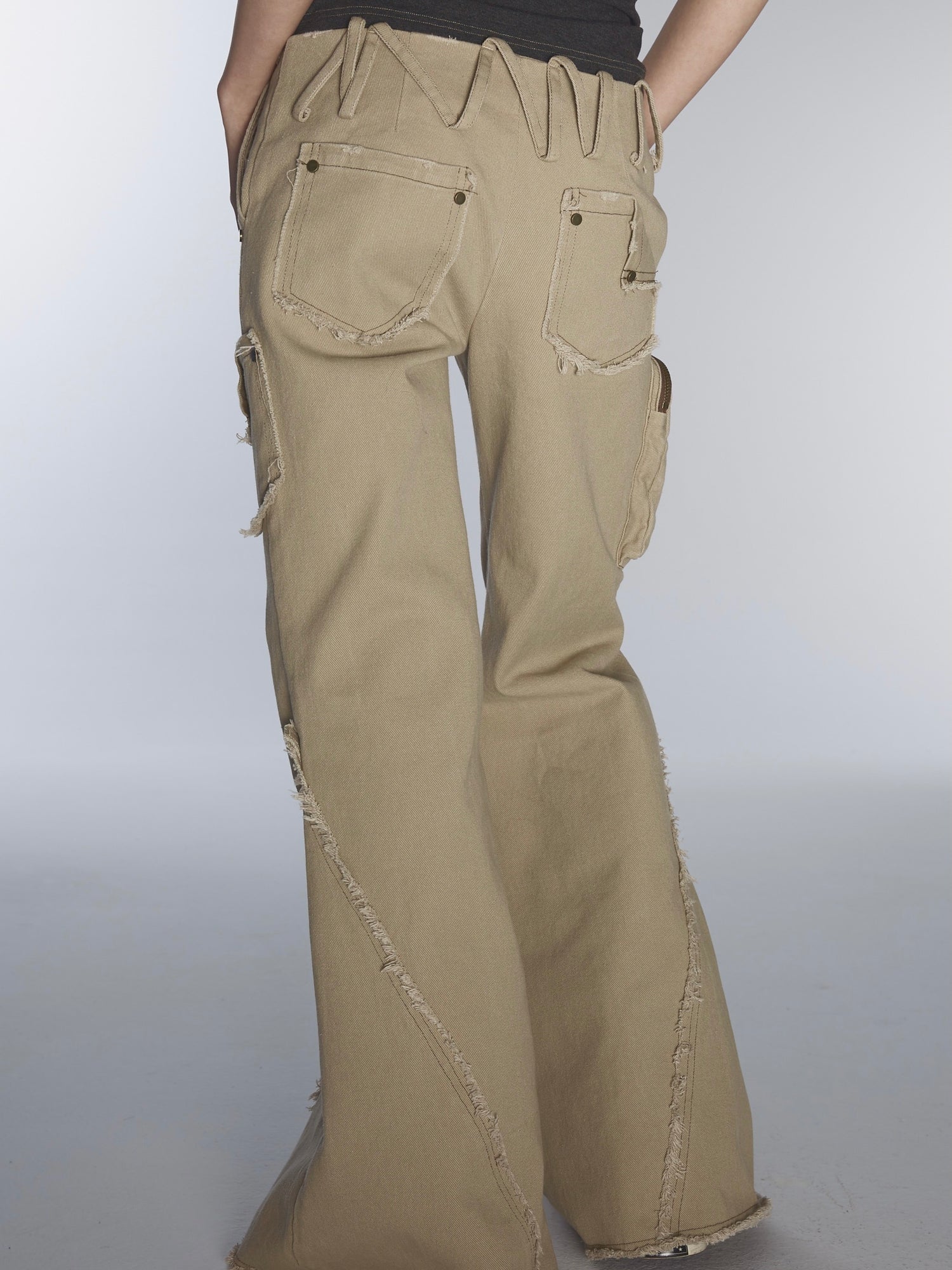 ULTRA-LOW WAIST RAW EDGE RIVET DENIM FLARED PANTS